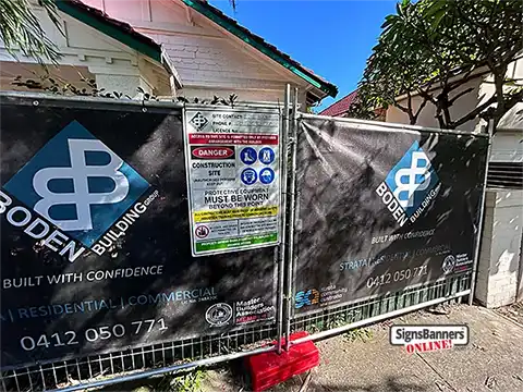 This temp fence on a worksite is screened with banner printing (mesh) for privacy and site identification. The banners serve as excellent marketing tools and are super cheap to order online.