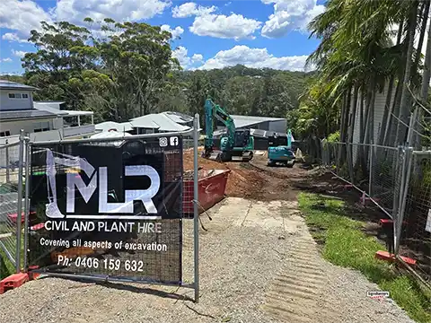single mesh banner sign for MLR civil and plant company. The black background is rich and deep, with a vivid white logo that stands out at street level.