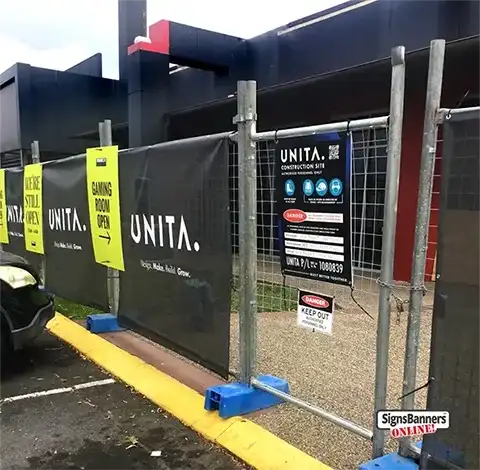 Shows panel repeat banners on a fence and gate safety site notices.