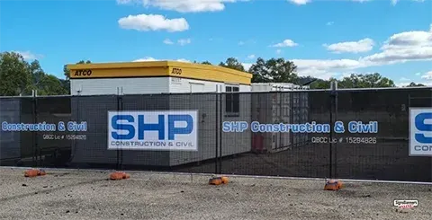 This is the wider view, showing the fence hire with printed banner shadecloth fitted. The print is blue with white outline.