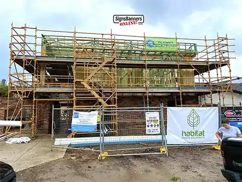 Worksite with a combination of scaffold, fence and site boards during the build.