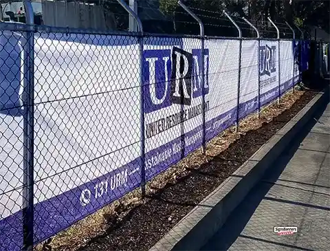 Full sunlight image showing the tiny holes 'show thru' of a mesh banner on a wire fence.