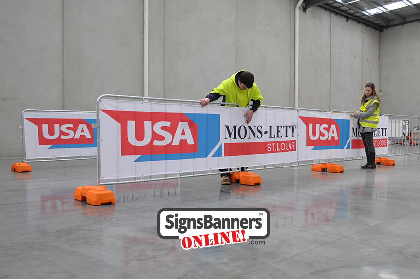 Event team installing the rent a fence banner covers for advertising a promoter